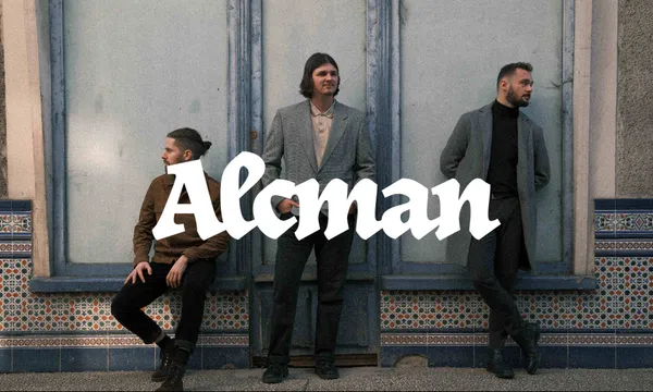 The three band members posing front of a textured wall, the logo is prominently overlaid in white, stylized text in the center of the image.